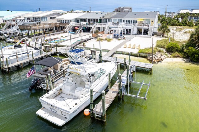 415 Gulf Shore Dr Unit 1, Destin, FL 32541 - dock area with boat lift, a deck with water view, and stairs