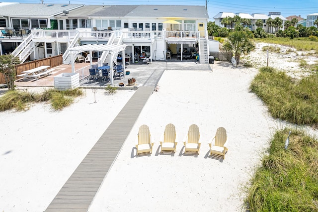 415 Gulf Shore Dr Unit 1, Destin, FL 32541 - rear view of house featuring stairway, a patio area, and a wooden deck