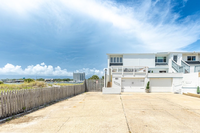 415 Gulf Shore Dr Unit 1, Destin, FL 32541 - rear view of house with concrete driveway and a garage