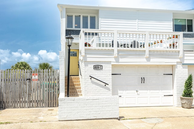 415 Gulf Shore Dr Unit 1, Destin, FL 32541 - view of front of property with a balcony, a garage, brick siding, and driveway