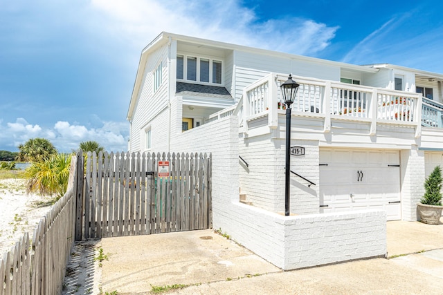 415 Gulf Shore Dr Unit 1, Destin, FL 32541 - view of home's exterior with a garage and a gate