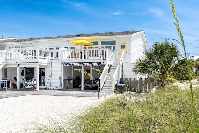 415 Gulf Shore Dr Unit 1, Destin, FL 32541 - back of house with stairway, a patio area, and a wooden deck