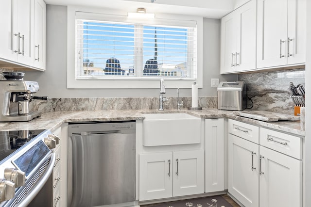 415 Gulf Shore Dr Unit 1, Destin, FL 32541 - kitchen with stainless steel appliances, white cabinets, light stone countertops, and backsplash