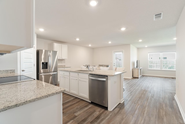 919 Sandbar Loop, Crestview, FL 32539 - kitchen with appliances with stainless steel finishes, wood finished floors, white cabinetry, light stone countertops, and recessed lighting