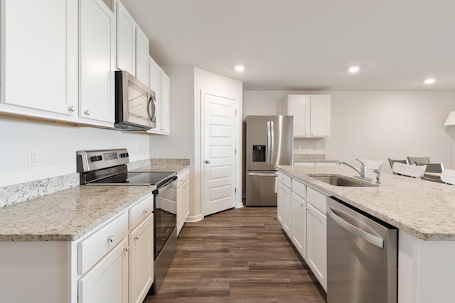 919 Sandbar Loop, Crestview, FL 32539 - kitchen featuring stainless steel appliances, an island with sink, dark wood-type flooring, recessed lighting, and white cabinets