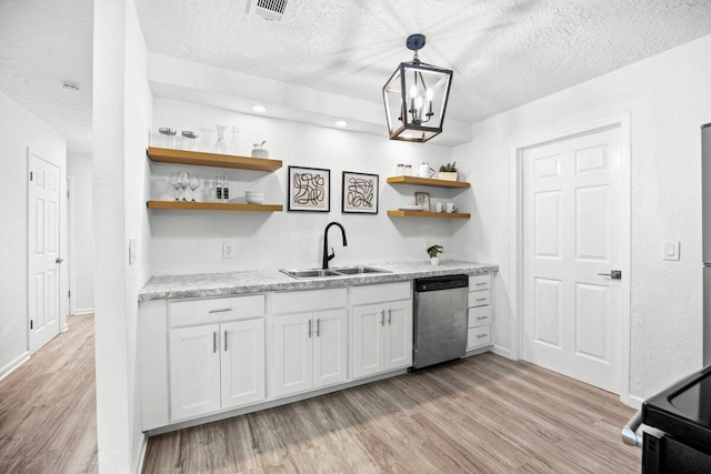 4352 Watkins St, Pace, FL 32571 - kitchen featuring stainless steel dishwasher, open shelves, light wood-type flooring, a textured ceiling, and white cabinets