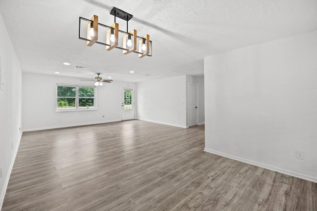 4352 Watkins St, Pace, FL 32571 - unfurnished living room featuring a textured ceiling, wood finished floors, a ceiling fan, a chandelier, and recessed lighting