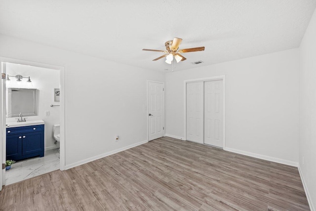 4352 Watkins St, Pace, FL 32571 - unfurnished bedroom with a closet, light wood-style floors, ensuite bathroom, and ceiling fan