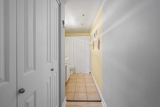 9900 S Thomas Dr Unit 2015, Panama City Beach, FL 32408 - hallway with light tile patterned flooring and baseboards