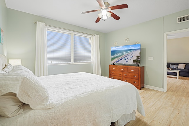 9900 S Thomas Dr Unit 2015, Panama City Beach, FL 32408 - bedroom featuring light wood finished floors and ceiling fan