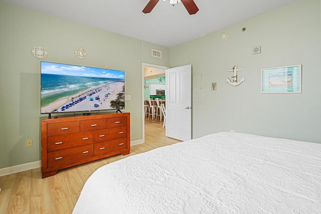 9900 S Thomas Dr Unit 2015, Panama City Beach, FL 32408 - bedroom with light wood-style flooring and a ceiling fan