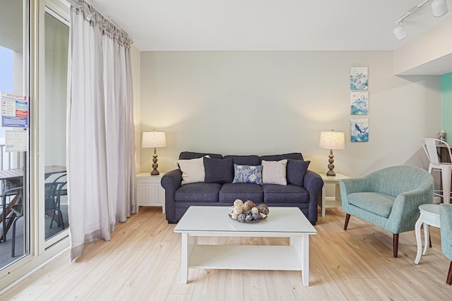 9900 S Thomas Dr Unit 2015, Panama City Beach, FL 32408 - living room with light wood-style flooring and rail lighting