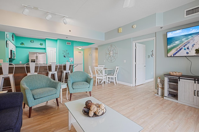 9900 S Thomas Dr Unit 2015, Panama City Beach, FL 32408 - living room featuring light wood-style floors and rail lighting