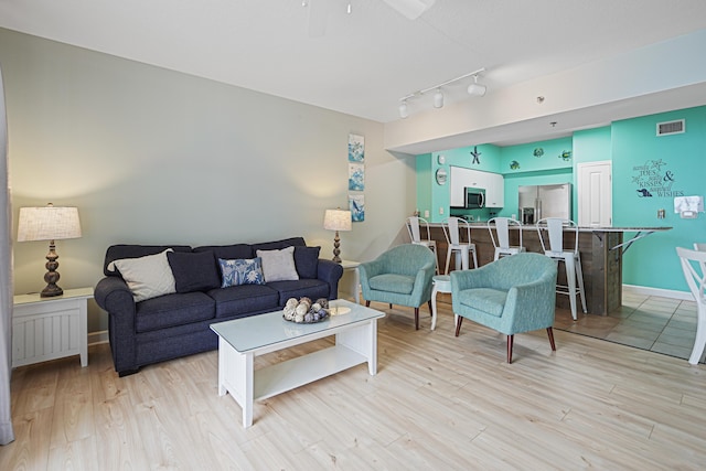 9900 S Thomas Dr Unit 2015, Panama City Beach, FL 32408 - living area with light wood-style floors, ceiling fan, and track lighting