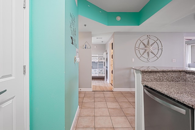 9900 S Thomas Dr Unit 2015, Panama City Beach, FL 32408 - kitchen featuring stainless steel dishwasher, light tile patterned flooring, stone counters, and a tray ceiling
