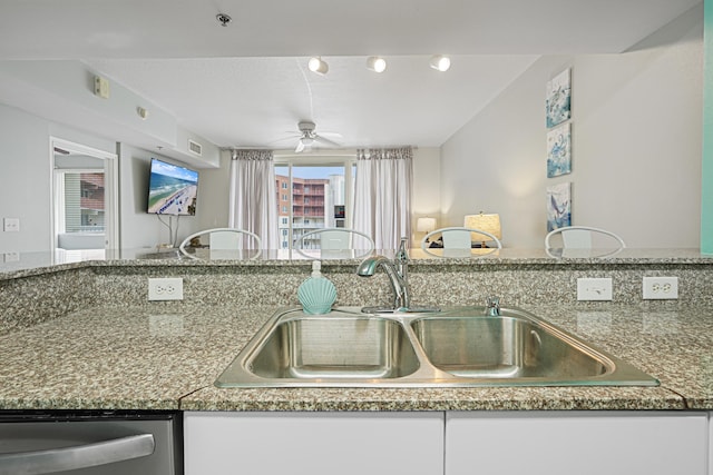 9900 S Thomas Dr Unit 2015, Panama City Beach, FL 32408 - kitchen with stainless steel dishwasher, ceiling fan, and white cabinetry