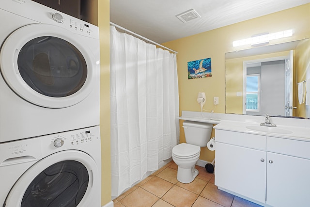 9900 S Thomas Dr Unit 2015, Panama City Beach, FL 32408 - laundry room with stacked washer / drying machine and light tile patterned floors