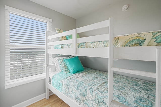 9900 S Thomas Dr Unit 2015, Panama City Beach, FL 32408 - bedroom featuring wood finished floors and baseboards