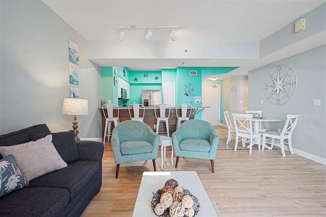 9900 S Thomas Dr Unit 2015, Panama City Beach, FL 32408 - living area with light wood-style flooring and track lighting