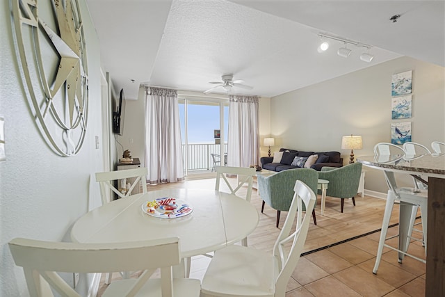 9900 S Thomas Dr Unit 2015, Panama City Beach, FL 32408 - dining space featuring a ceiling fan, light tile patterned flooring, rail lighting, and a textured ceiling