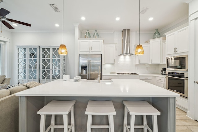 309 Milestone Dr Unit A, Inlet Beach, FL 32461 - kitchen with stainless steel appliances, wall chimney exhaust hood, tasteful backsplash, ceiling fan, and ornamental molding