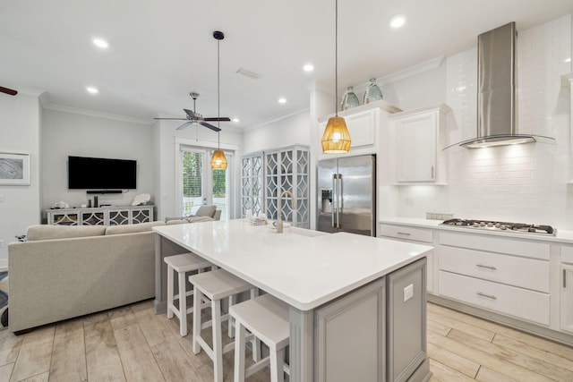 309 Milestone Dr Unit A, Inlet Beach, FL 32461 - kitchen with stainless steel fridge, wall chimney range hood, gas stovetop, ceiling fan, and backsplash