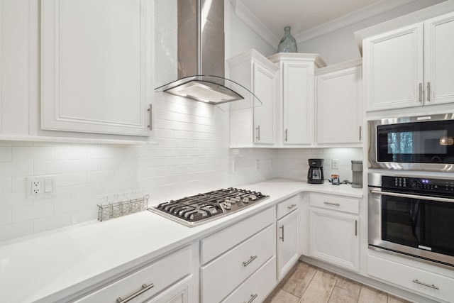 309 Milestone Dr Unit A, Inlet Beach, FL 32461 - kitchen featuring wall chimney exhaust hood, stainless steel appliances, crown molding, white cabinets, and backsplash