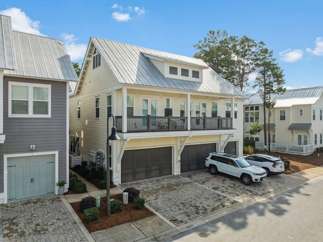 309 Milestone Dr Unit A, Inlet Beach, FL 32461 - view of property featuring an attached garage, driveway, a metal roof, and a balcony