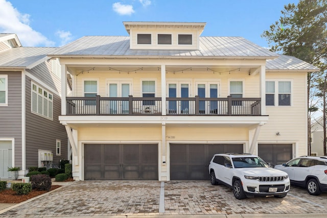 309 Milestone Dr Unit A, Inlet Beach, FL 32461 - view of property featuring an attached garage, a balcony, a metal roof, and decorative driveway