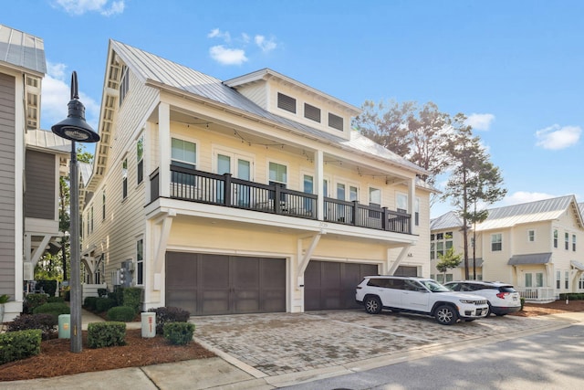 309 Milestone Dr Unit A, Inlet Beach, FL 32461 - multi unit property featuring an attached garage, a balcony, a metal roof, and driveway