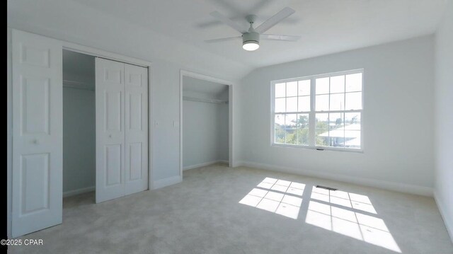 7202 Ranier St, Panama City, FL 32404 - unfurnished bedroom with carpet floors, two closets, vaulted ceiling, and a ceiling fan