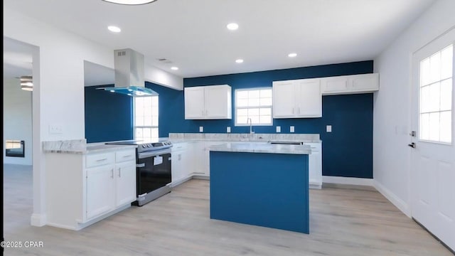 7202 Ranier St, Panama City, FL 32404 - kitchen with island range hood, stainless steel electric range, a kitchen island, light countertops, and white cabinets