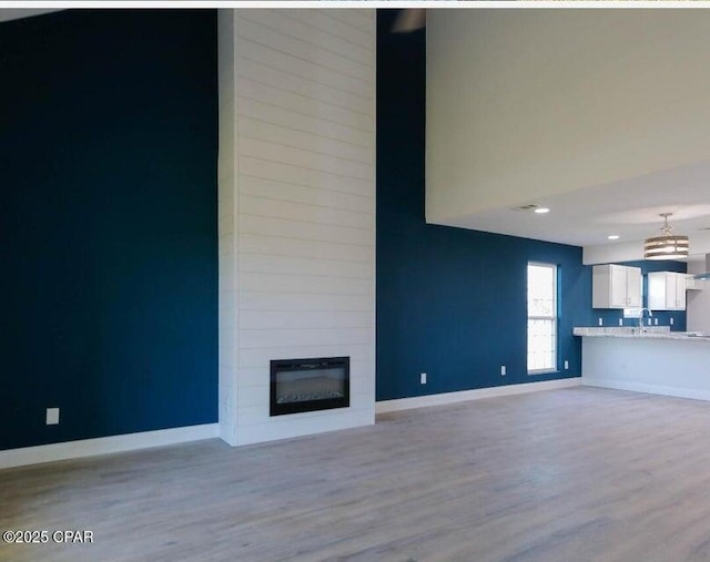 7202 Ranier St, Panama City, FL 32404 - unfurnished living room featuring light wood finished floors and a fireplace