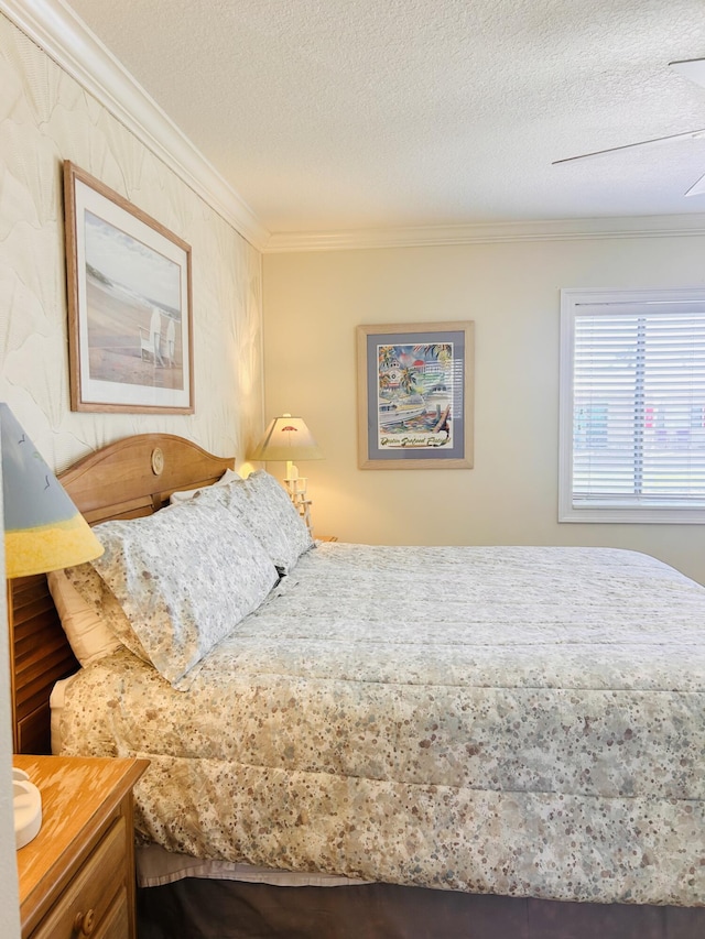 3100 Scenic Highway 98 Unit 118, Destin, FL 32541 - bedroom with ornamental molding, a textured ceiling, and a ceiling fan