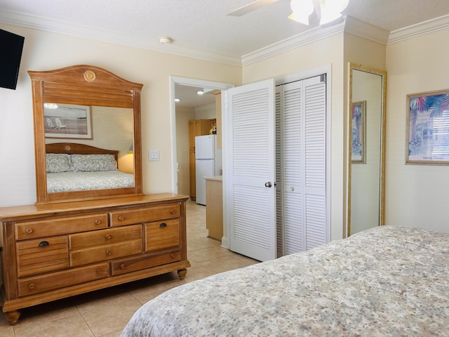 3100 Scenic Highway 98 Unit 118, Destin, FL 32541 - bedroom featuring freestanding refrigerator, crown molding, light tile patterned floors, a closet, and a ceiling fan
