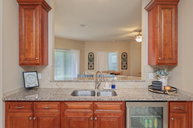 4530 Annabelle Ln, Crestview, FL 32539 - kitchen with wine cooler, tasteful backsplash, a ceiling fan, and light stone counters