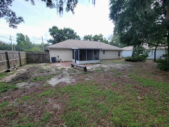 6868 E Bay Blvd, Navarre, FL 32566 - back of property with a sunroom and a gate