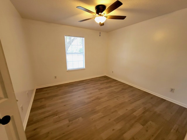 6868 E Bay Blvd, Navarre, FL 32566 - empty room featuring dark wood-style flooring and a ceiling fan
