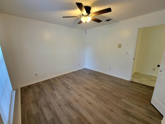 6868 E Bay Blvd, Navarre, FL 32566 - unfurnished room with ceiling fan and wood finished floors