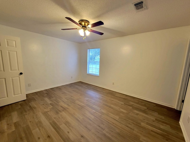 6868 E Bay Blvd, Navarre, FL 32566 - unfurnished room with a ceiling fan, dark wood-style floors, and a textured ceiling