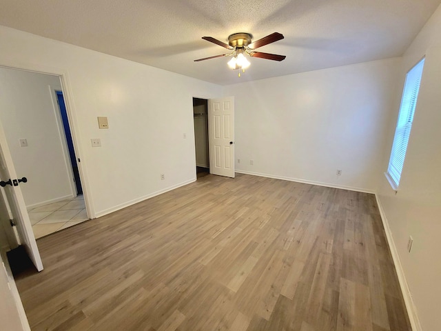 6868 E Bay Blvd, Navarre, FL 32566 - empty room with ceiling fan and wood finished floors