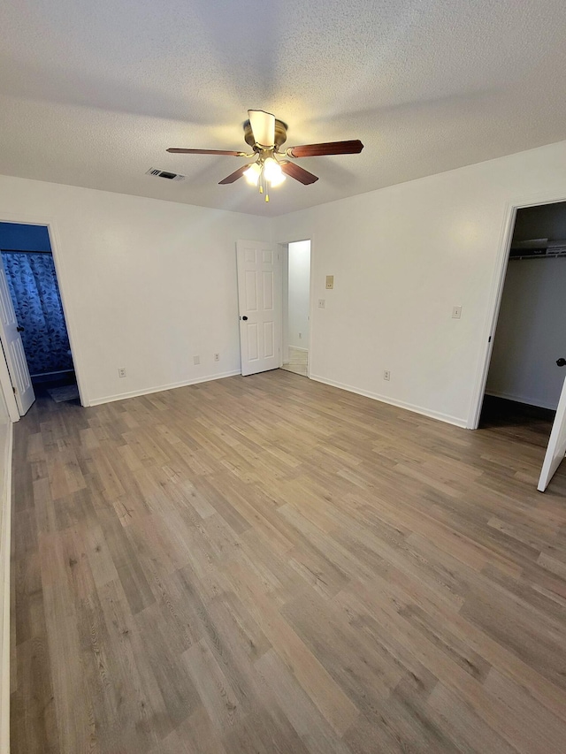6868 E Bay Blvd, Navarre, FL 32566 - empty room featuring a ceiling fan, wood finished floors, and a textured ceiling