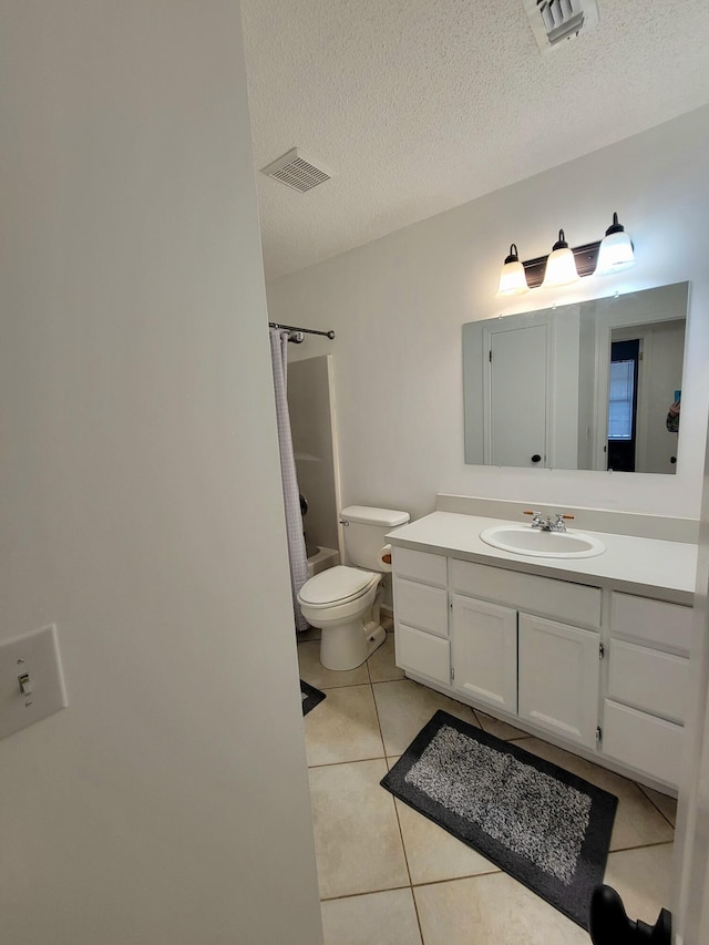 6868 E Bay Blvd, Navarre, FL 32566 - bathroom with vanity, tile patterned flooring, and a textured ceiling