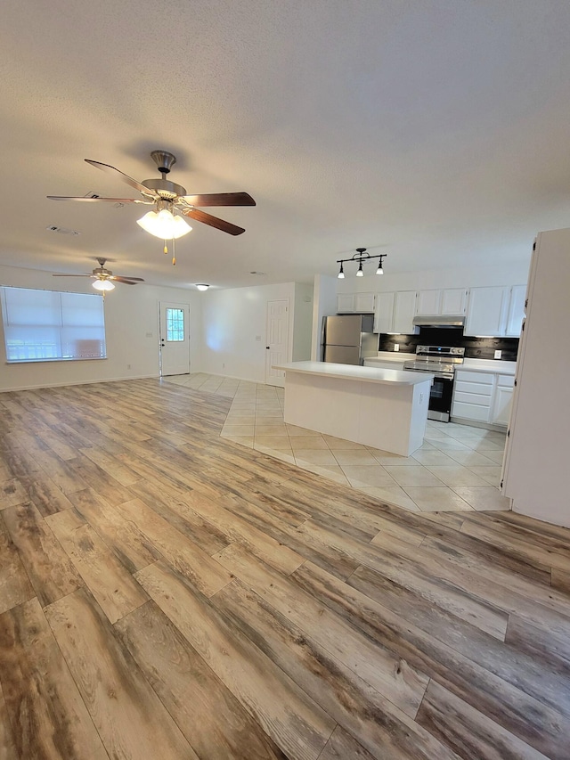 6868 E Bay Blvd, Navarre, FL 32566 - unfurnished living room featuring light wood-style floors and a ceiling fan