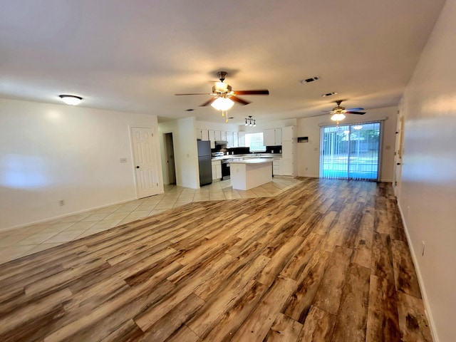 6868 E Bay Blvd, Navarre, FL 32566 - unfurnished living room featuring light wood-type flooring and a ceiling fan