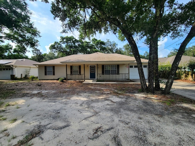 6868 E Bay Blvd, Navarre, FL 32566 - ranch-style house featuring a garage and covered porch