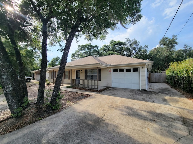 6868 E Bay Blvd, Navarre, FL 32566 - ranch-style house with a porch, a garage, and concrete driveway