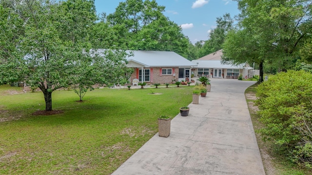 4936 Grassy Pond Rd, Chipley, FL 32428 - ranch-style home with concrete driveway and a front yard
