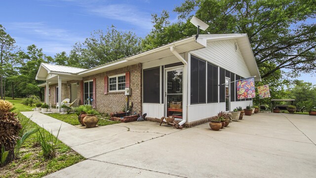 4936 Grassy Pond Rd, Chipley, FL 32428 - view of front facade featuring a sunroom and brick siding