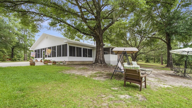 4936 Grassy Pond Rd, Chipley, FL 32428 - back of property featuring a sunroom and a lawn